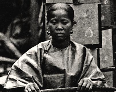 A Black Chinese woman sorting tea leaves